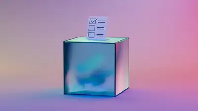 A hand slips a folded paper ballot into a ballot box