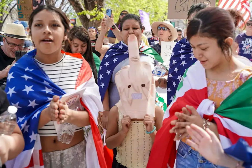 Demonstrators carry American and Mexican flags at an immigration rally.