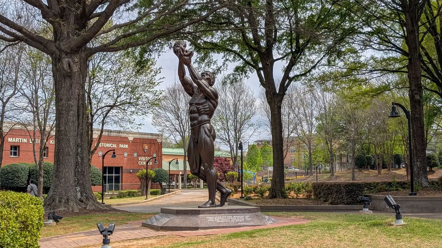 Statue at MLK Jr. Historical Park, Atlanta, surrounded by spring foliage.