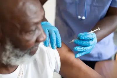 A man receiving a shot in his arm