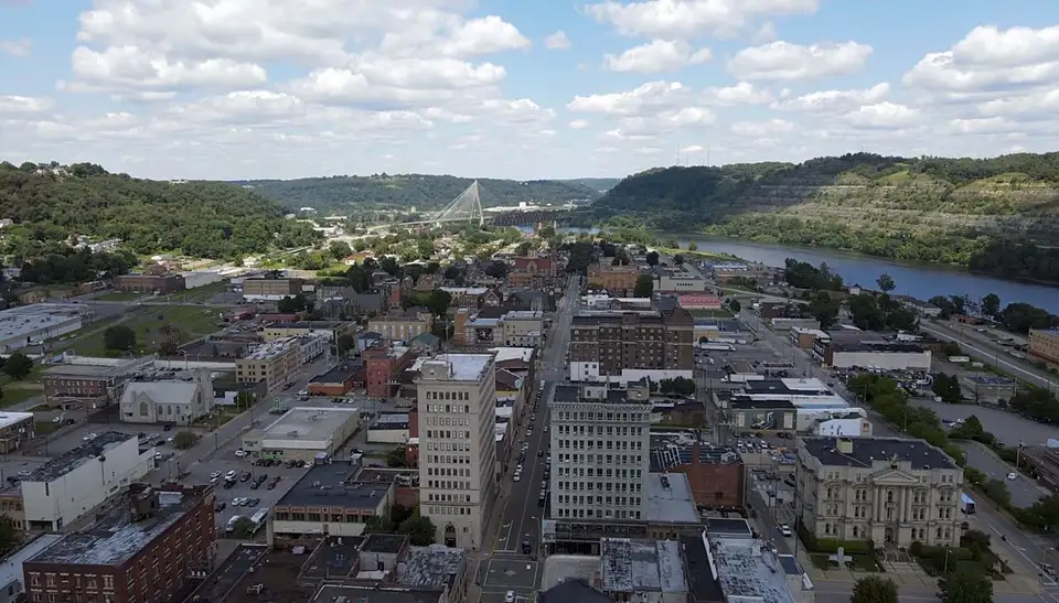 Aerial view of downtown Steubenville, Ohio along the Ohio River, the Veterans Memorial Bridge spanning the water beyond the city grid.