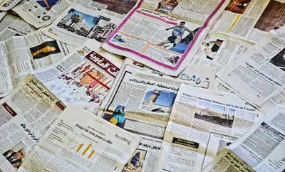 Newspapers spread out showing headlines