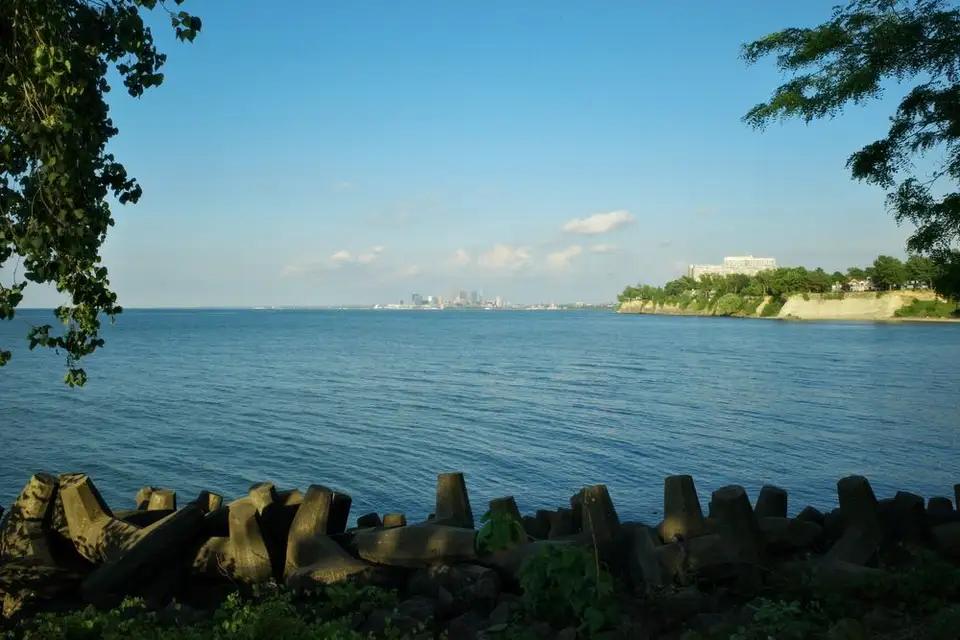 The Cleveland skyline seen across the water from a Lake Erie shoreline park.