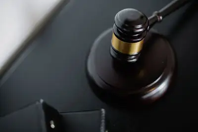 A wooden judge's gavel beside case folders