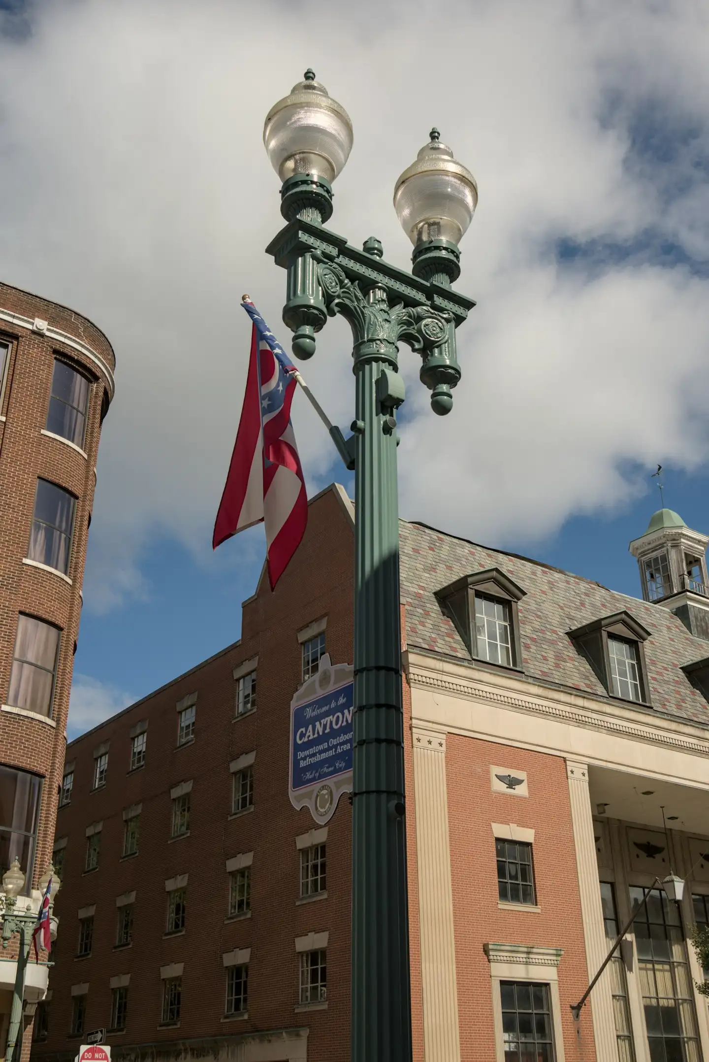 Ornate lamppost with American flags in front of downtown Canton, Ohio buildings