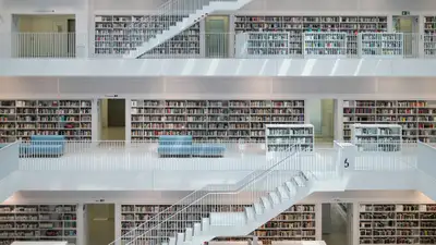 Modern library interior with many bookshelves and stairs