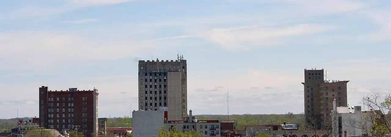 Downtown Lima, Ohio skyline, its mid-century office towers rising under a broad spring sky.