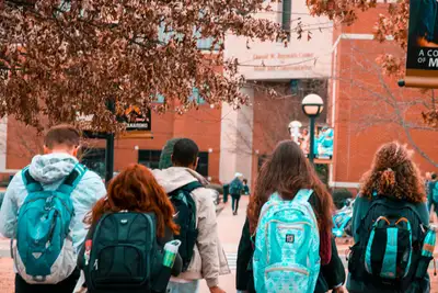 College students with backpacks walking together across campus