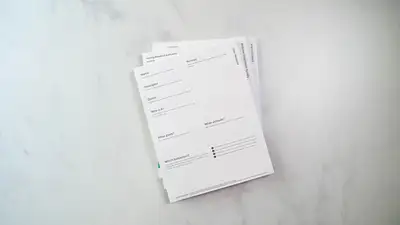 A stack of medical bills and paperwork on a counter